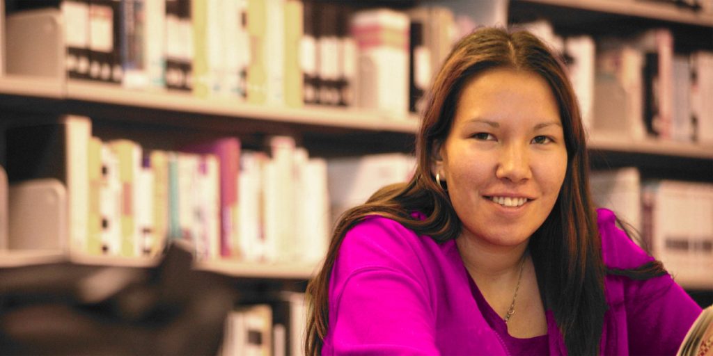 A young indigenous woman in a library.