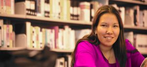 A young indigenous woman in a library.