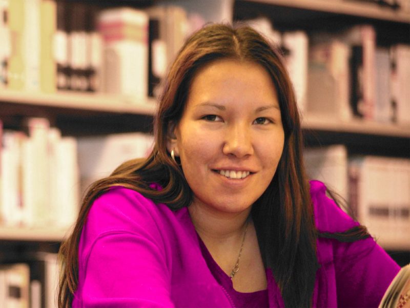 A young indigenous woman in a library.