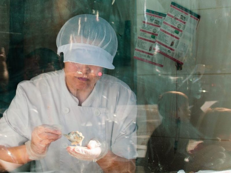 A woman packing meat.