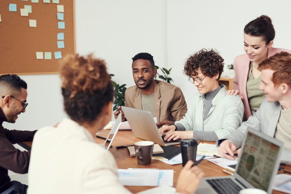 young professionals in a group meeting discussing work.