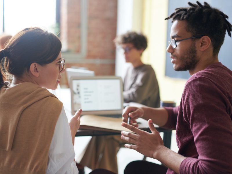 A man and a woman discussing work.