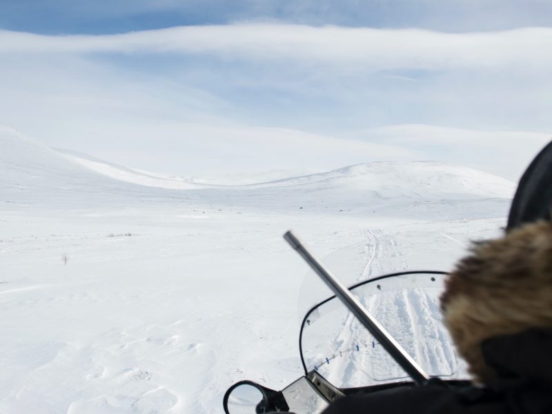 Riding a snowmobile in Northern Canada