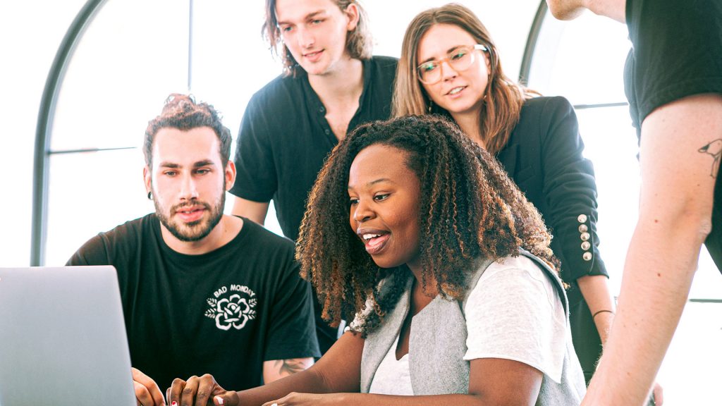 Diverse youth working together at a laptop