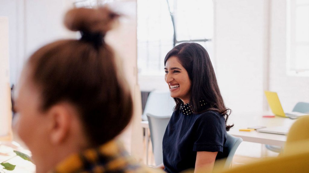 Seated person smiling during a meeting