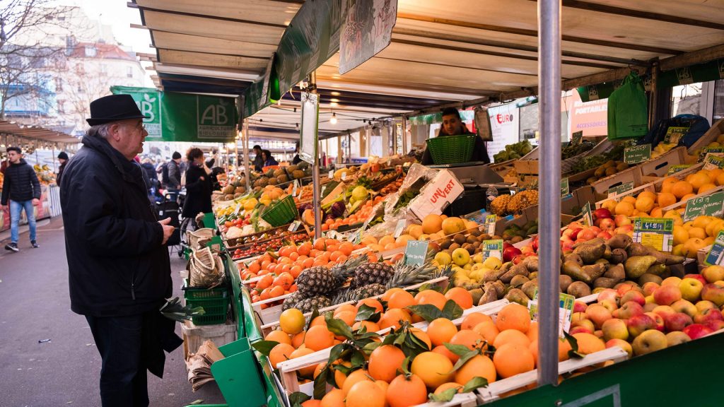 Person at an outdoor fruit and vegetable market