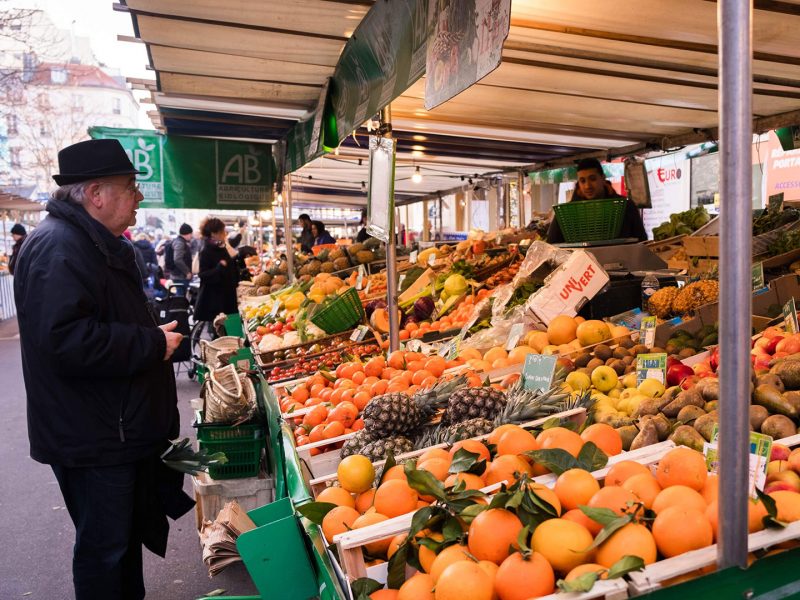 Person at an outdoor fruit and vegetable market