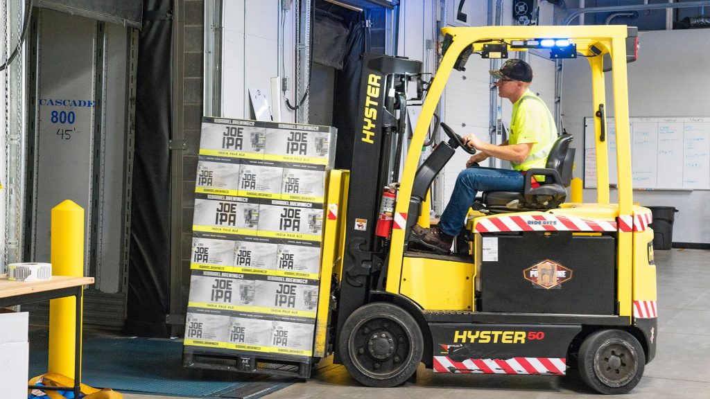 Forklift operator moving a pallet of goods