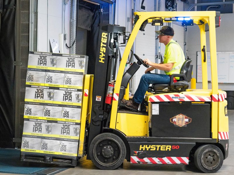 Forklift operator moving a pallet of goods