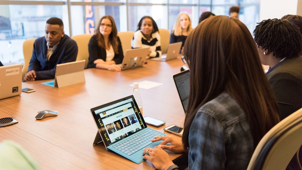 Diverse team on laptops having a group meeting