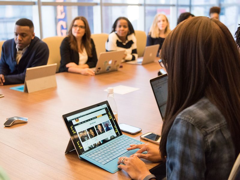 Diverse team on laptops having a group meeting