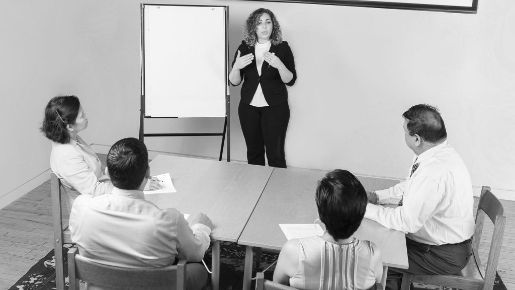 Person giving a whiteboard presentation to a group