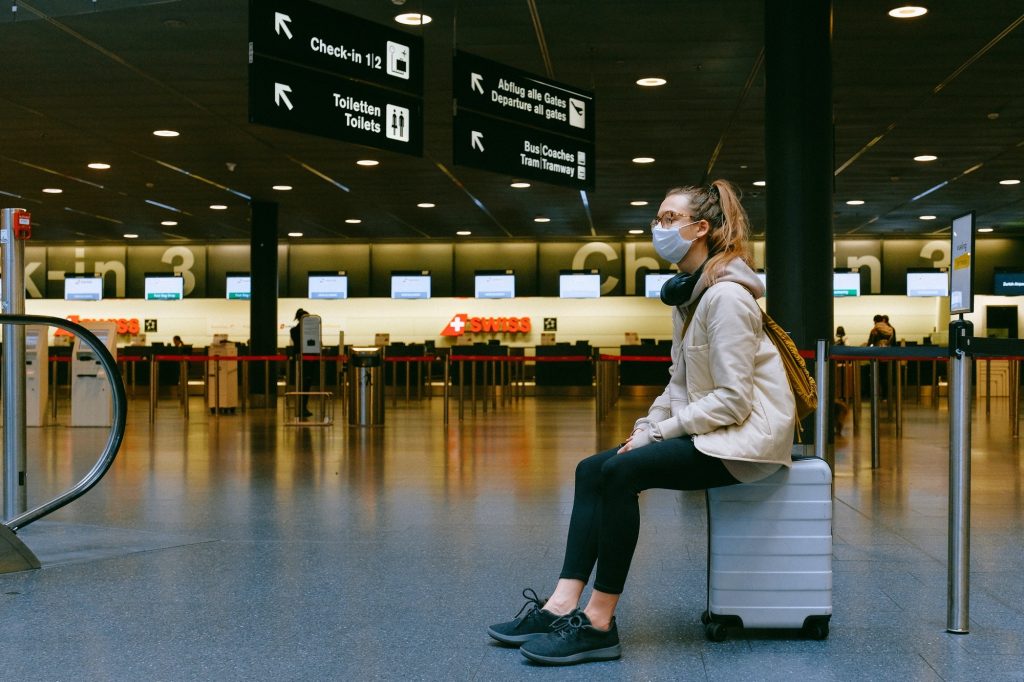 woman sitting on luggage at the Swiss airport