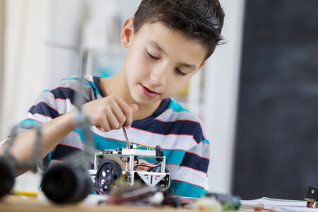 Young boy working on robot project