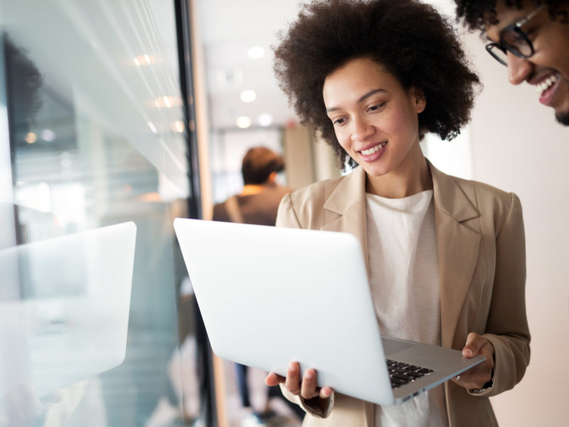 Young woman looking at her opened laptop