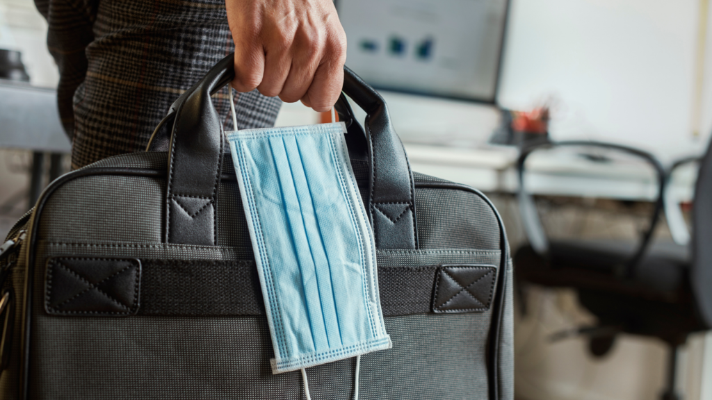 man with a briefcase and a surgical mask