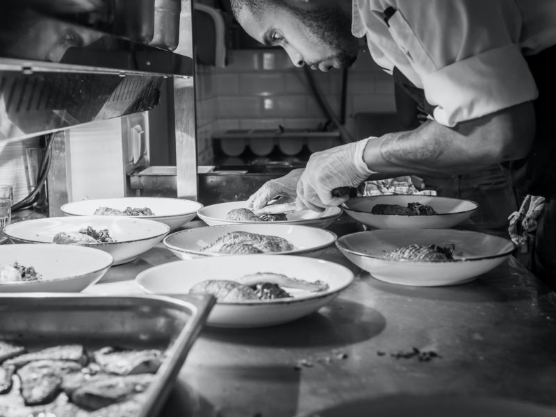 Man preparing plates in the kitchen.