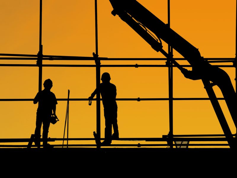 Two workers in a construction site.