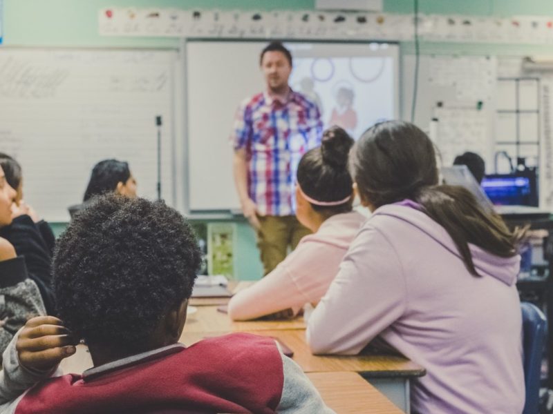 Teacher talking to students in class.