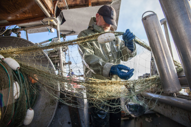 Man making a fishing net.