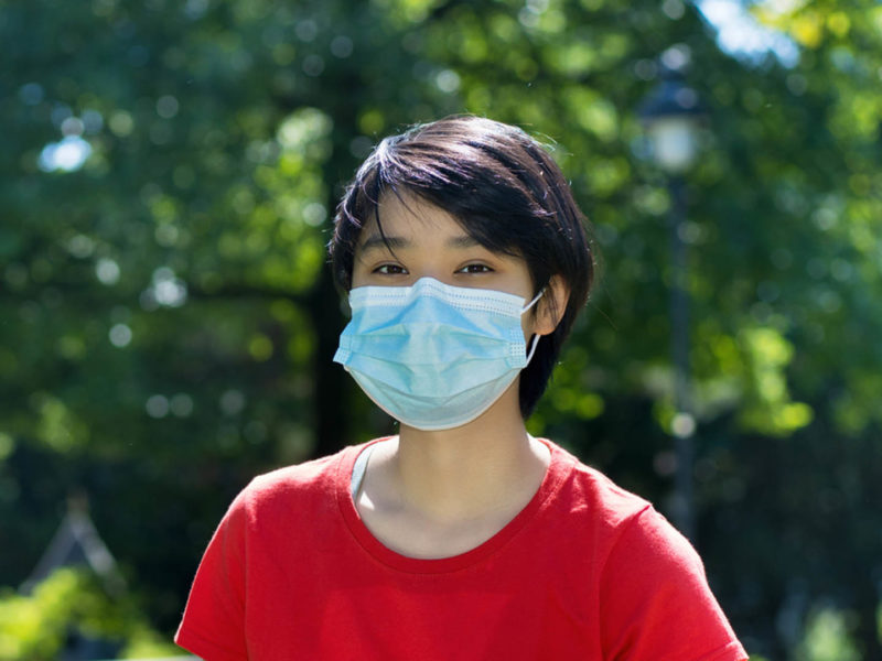 Student with face mask at campus of university