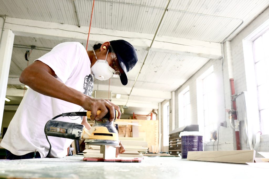 Image of a gentleman using a sanding machine.