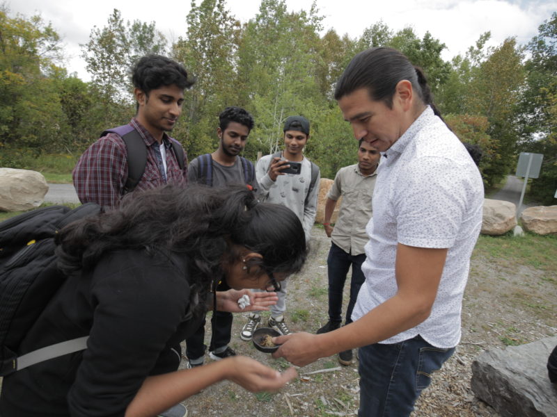 Students on a field trip peering in a bowl