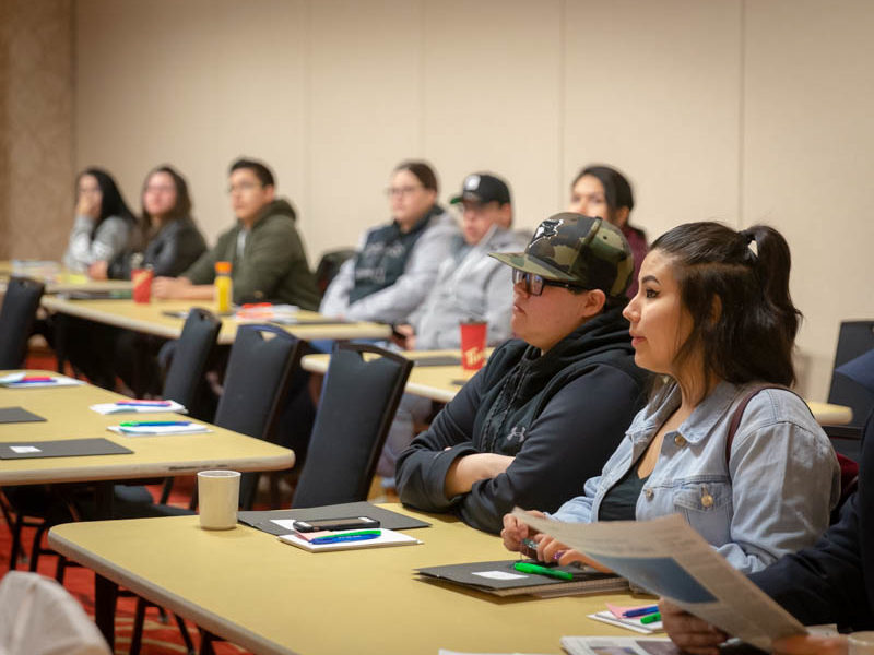 Group of students listening in a classroom.