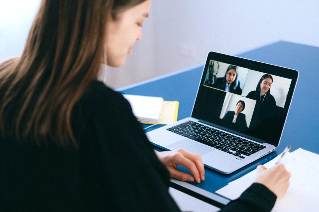 Person attends a video chat on a laptop