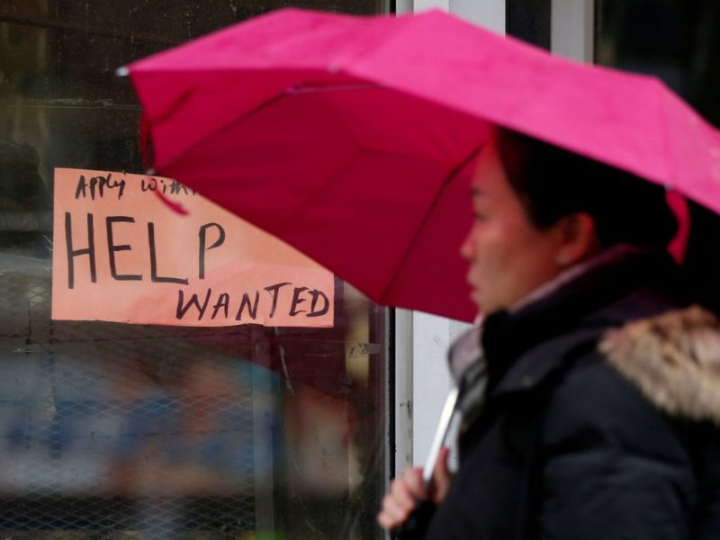 A person walks past a help wanted sign in Ottawa.