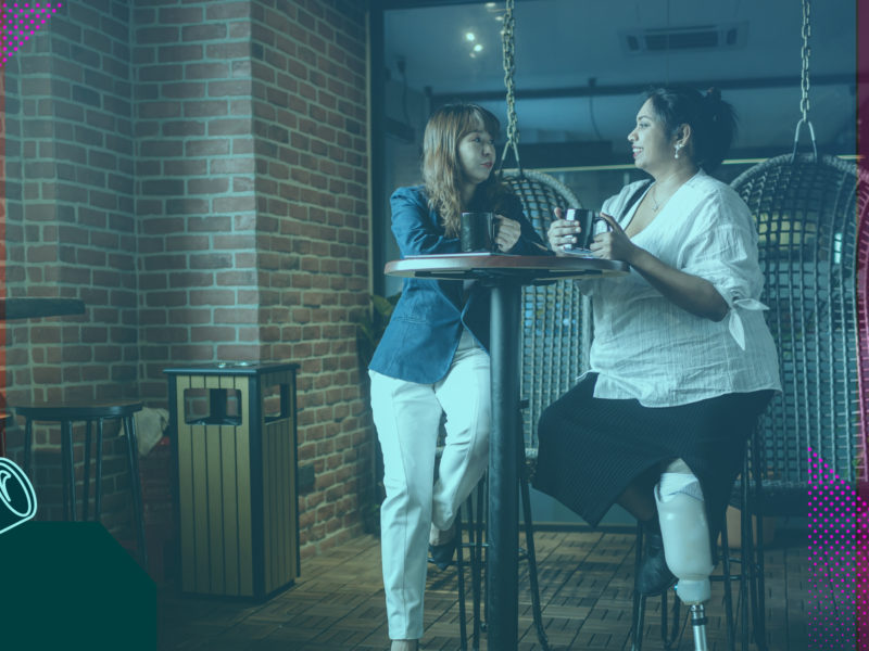 Two people chatting at a coffee table