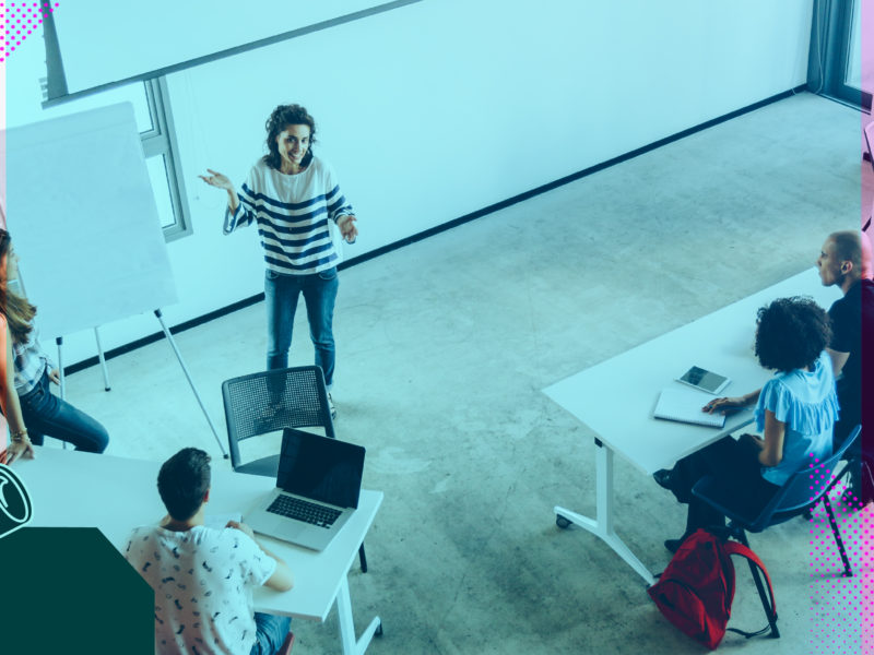 Person persenting in front of white board to an audience