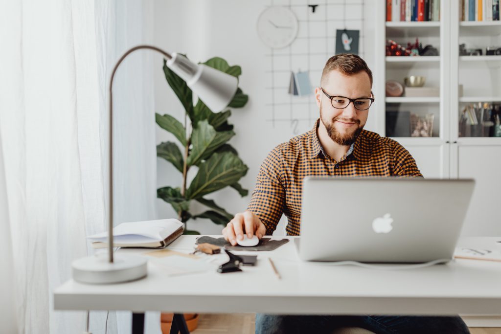 worker sitting at a desk and smiling