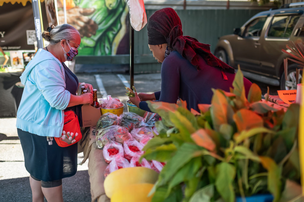 two people at an outdoor market representing Black entrepreneurship and business