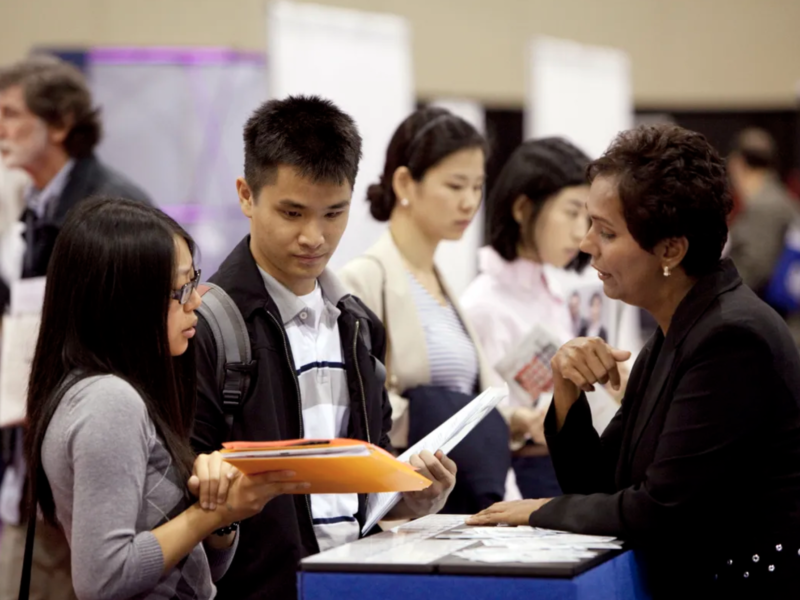 Attendees speak to a Resume World Inc. representative during the 19th edition of the National Job Fair and Training Expo at the Metro Toronto Convention Centre on Sept. 27, 2011. A recent study raised concerns that many Canadians don’t know what careers services are or how to access them at a time when many have experienced employment changes as a result of the pandemic. THE GLOBE AND MAIL