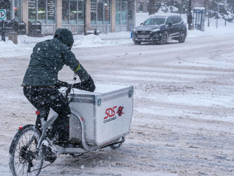 courier delivers packages in thick snow