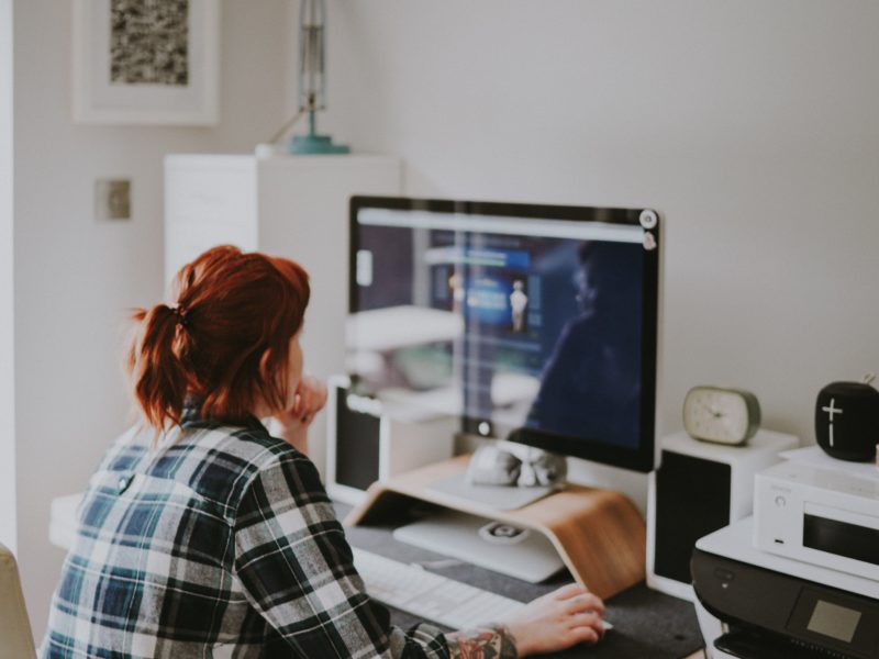 red-haired person works at a computer