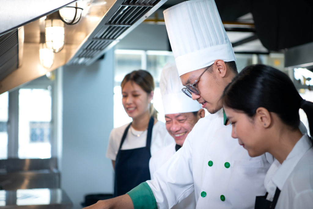 Portrait of a group of chefs and culinary students in the culinary Institute's kitchen.