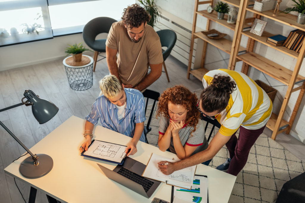 Coworkers working together in the office with the help of technology