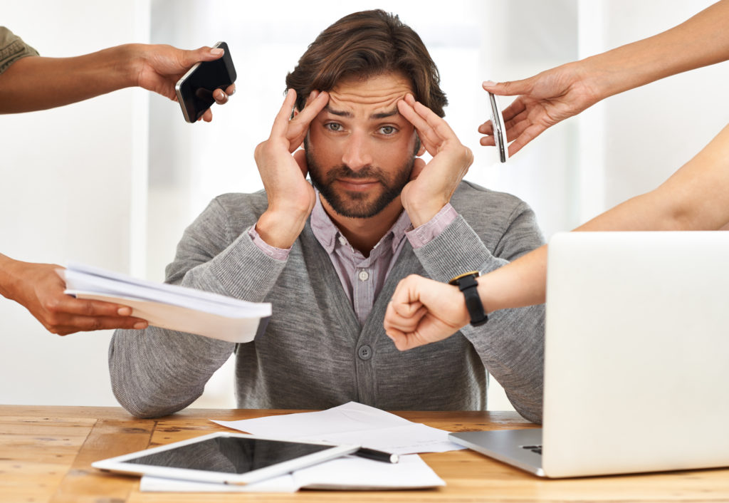 A stressed businessman working on his laptop