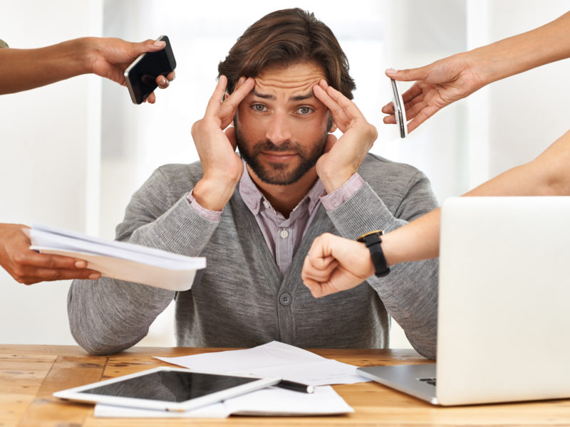 A stressed businessman working on his laptop