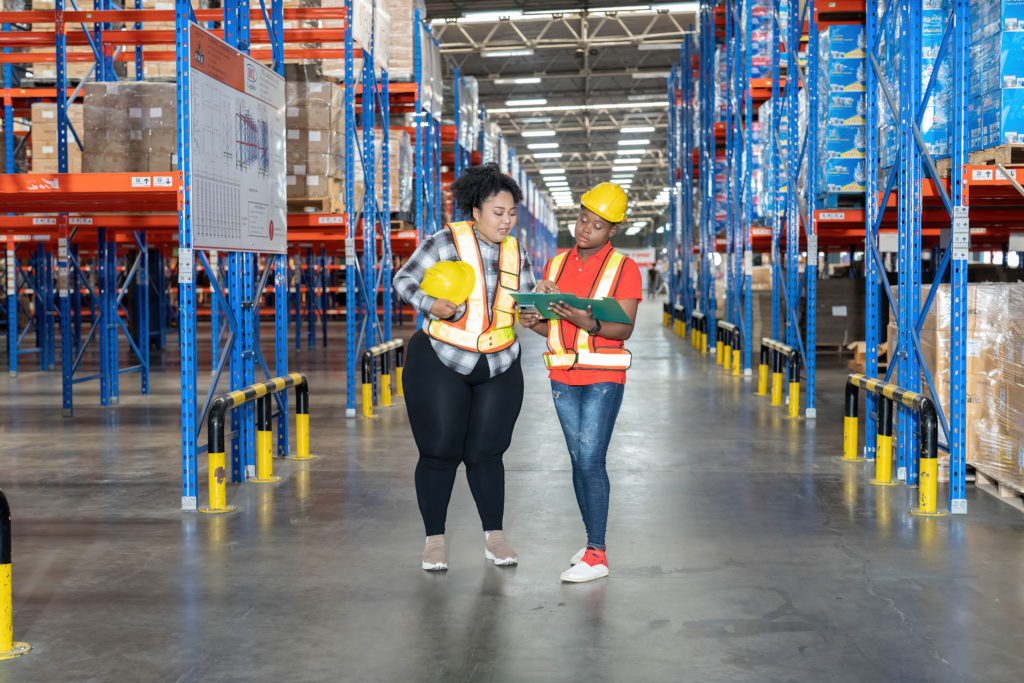 Worker in warehouse holding clip board