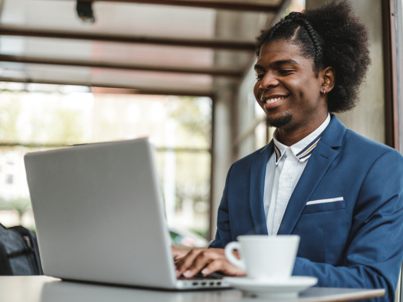 businessman using laptop in cafe