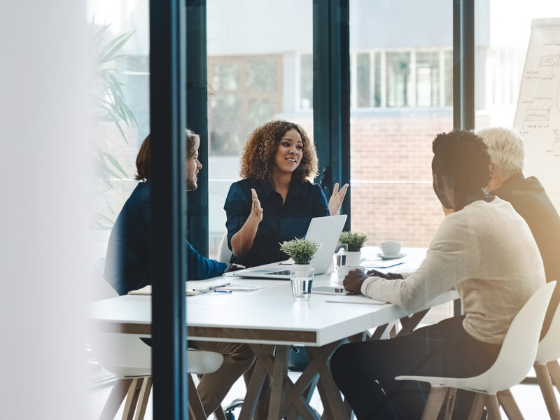 Planning, teamwork and meeting with business people in boardroom for strategy, brainstorming and solution. Corporate, collaboration and conference with employees in office for negotiation development.