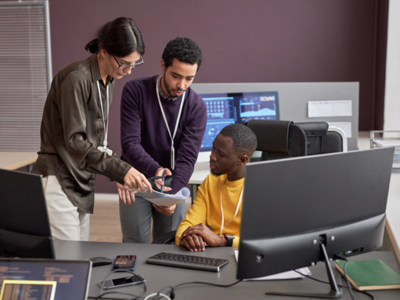 Group of business people collaborating on project in IT development office