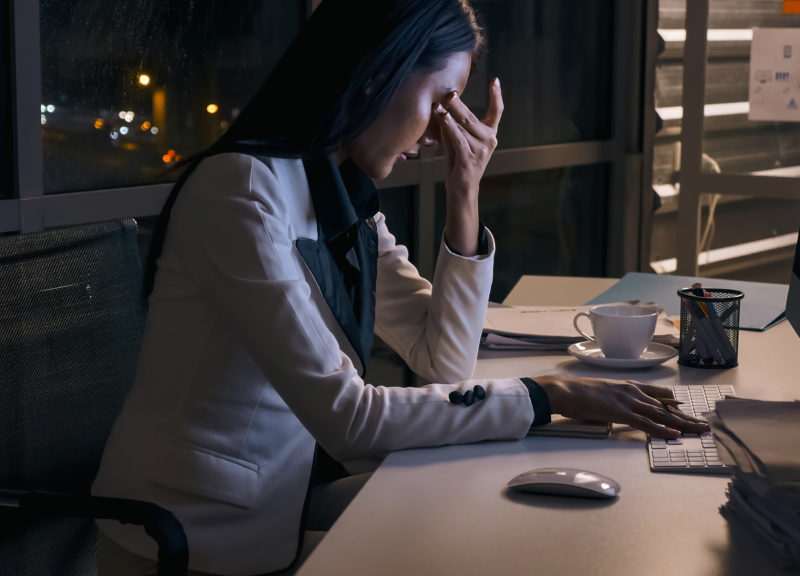 Stressed businesswoman working overtime at the office