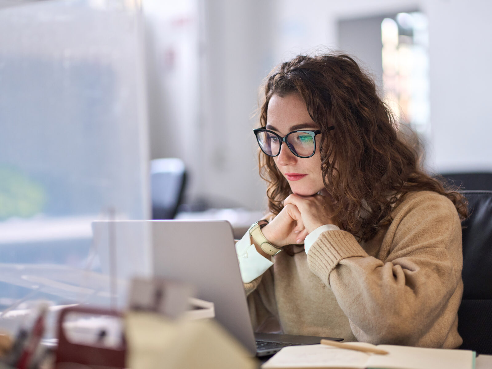 Young serious busy professional using laptop