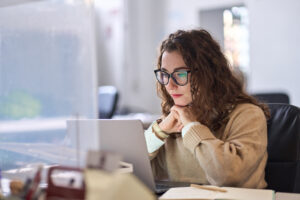 Young serious busy professional using laptop