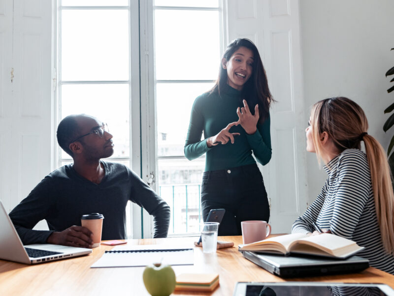 Person giving a whiteboard presentation to a group