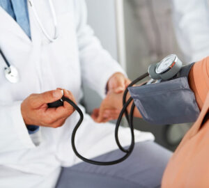 doctor taking blood pressure of a patient